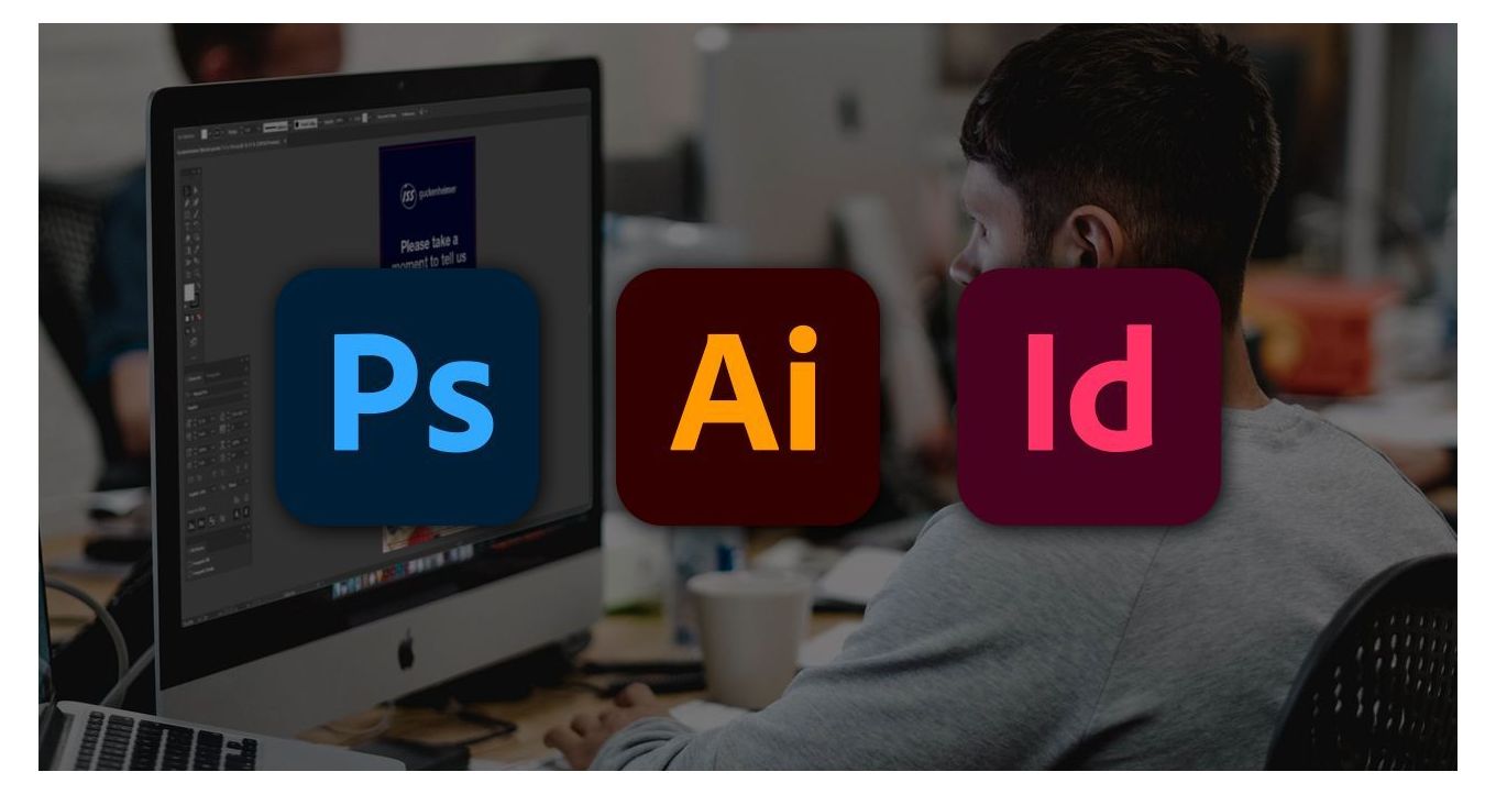 A graphic designer setting up a print file on a computer with Adobe Photoshop, Illustrator and InDesign logos on top of the image.
