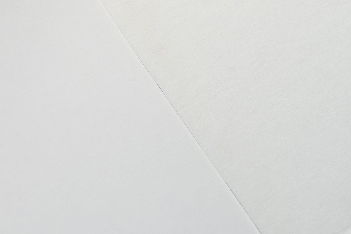 Image showing the difference between coated and uncoated paper for Card Sleeve Envelope Fold-Over Tuck.