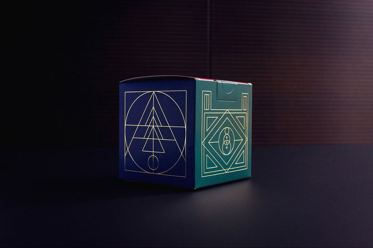 Example of graphic design trends for 2022 –art deco style dark green packaging box with golden details