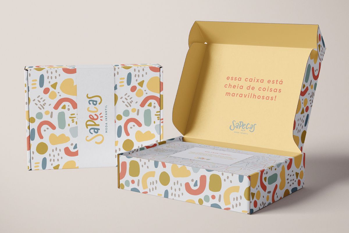 Opened and closed colorful boxes with a clothing packaging design.