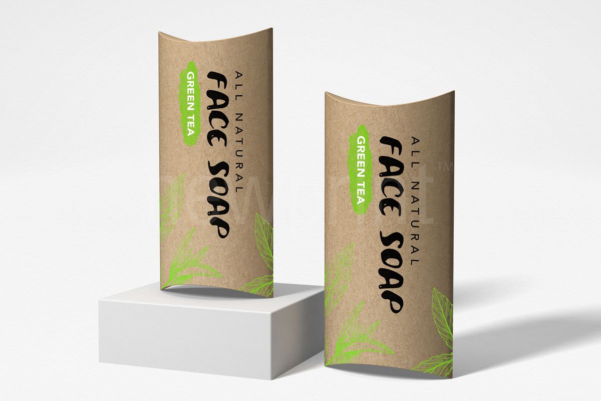 What is custom packaging - Two upright pillow boxes made of kraft paper against a gray background, with a design for a natural face soap applied to the boxes.