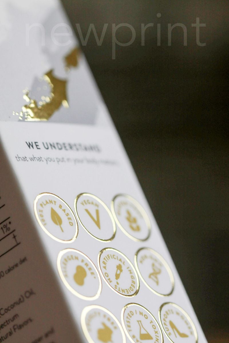 Close-up of a luxury packaging design, showing gold foil and emboss details.