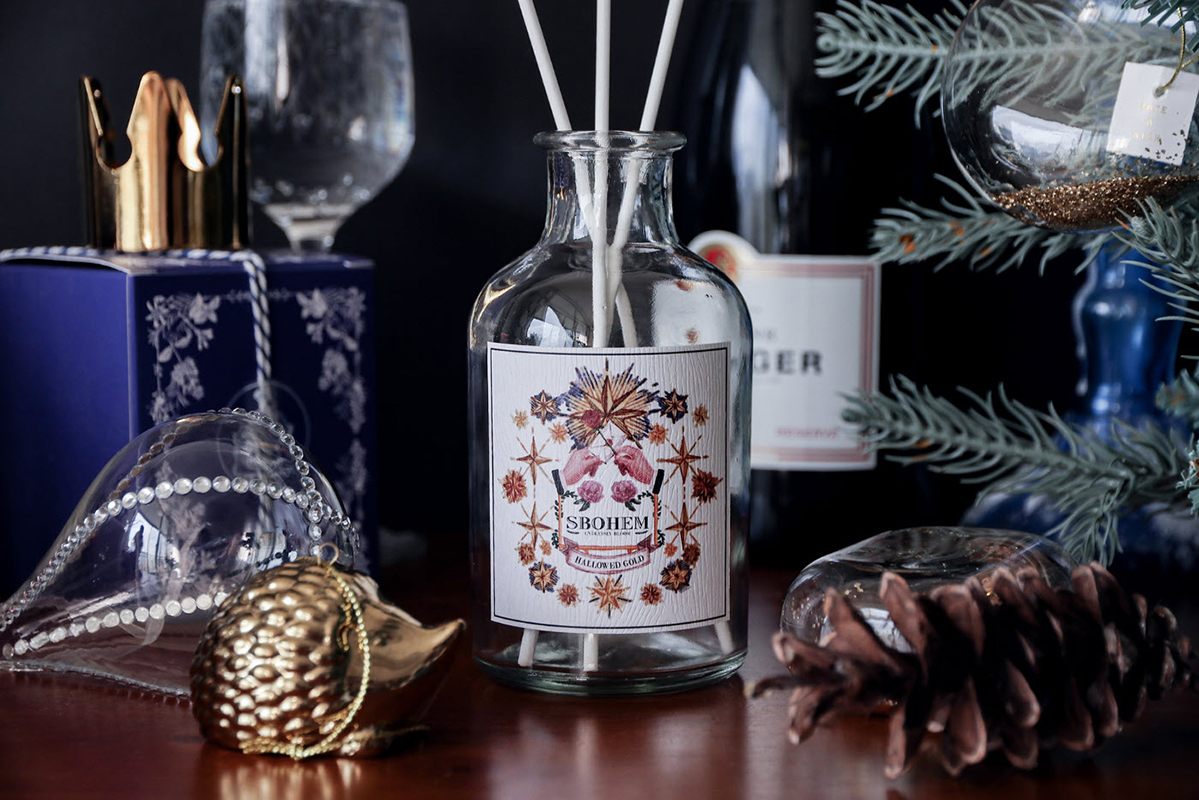 Christmas packaging design inspiration, glass bottle with a Christmas-themed label attached.