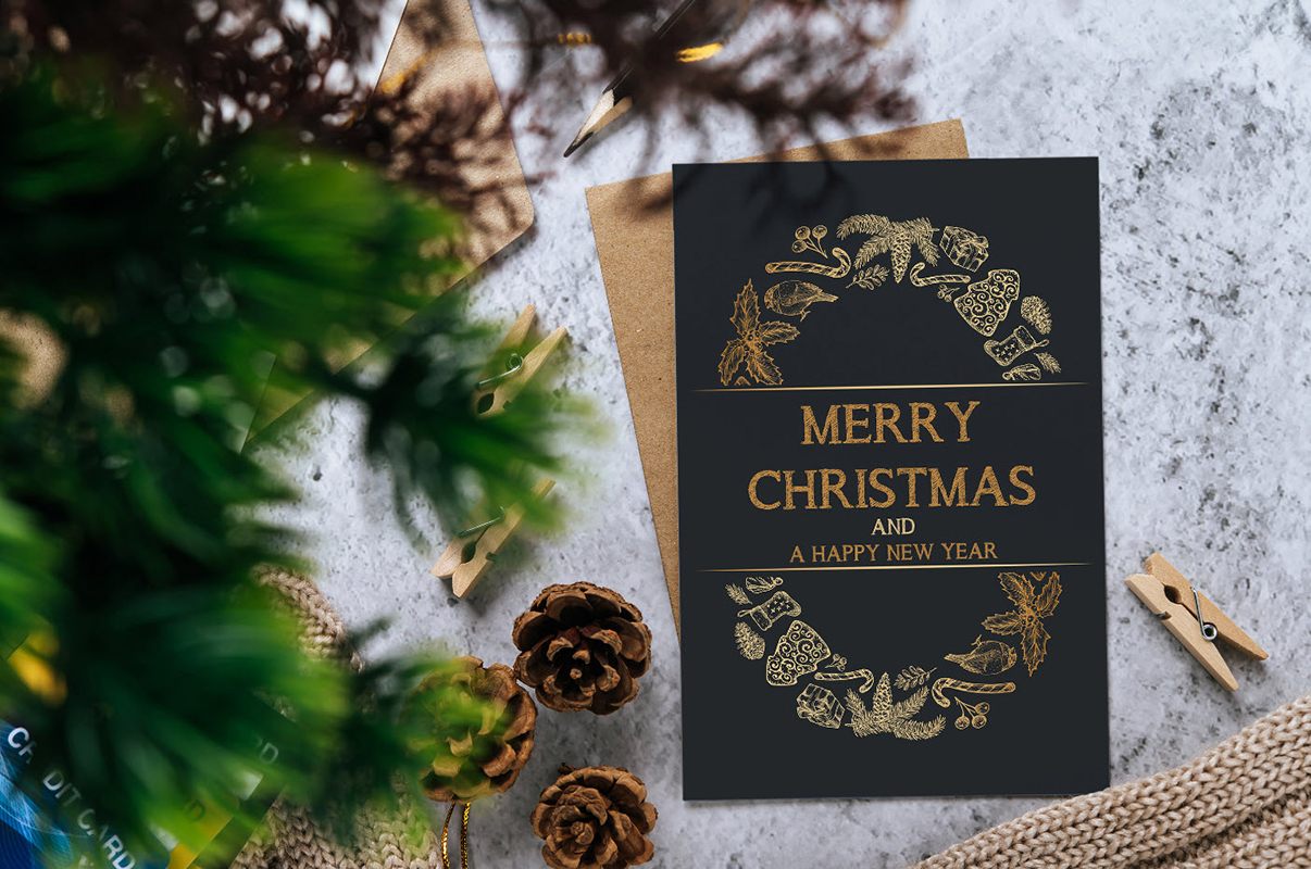 Christmas packaging design inspiration, Christmas postcard and an envelope on a table.