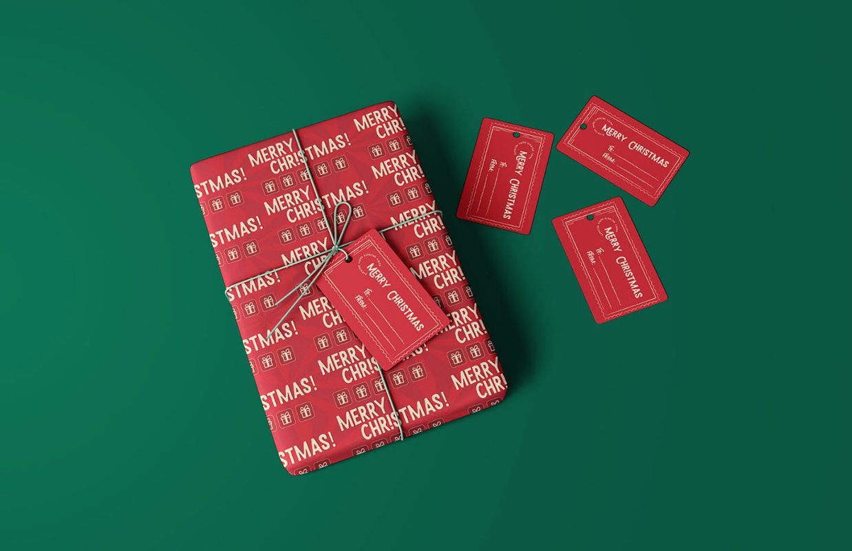 Christmas packaging design inspiration, wrapped present with a hang tag attached and three other hang tags next to the box.