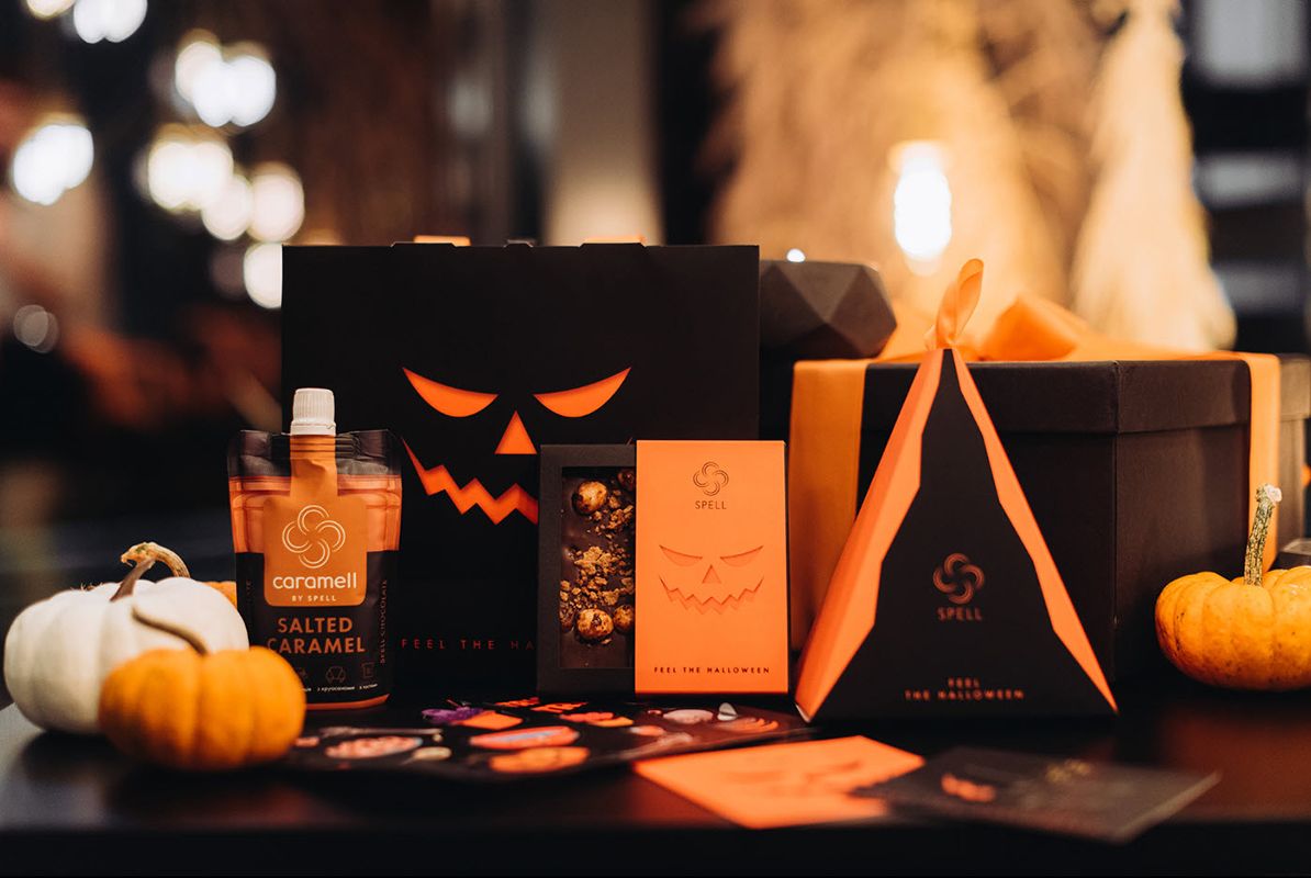 Different elegant black and orange Halloween candy packaging boxes.