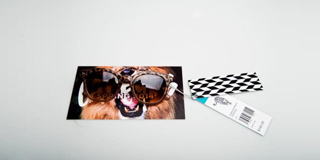Custom hang tags for sunglasses, with a card that has lion design in the background.