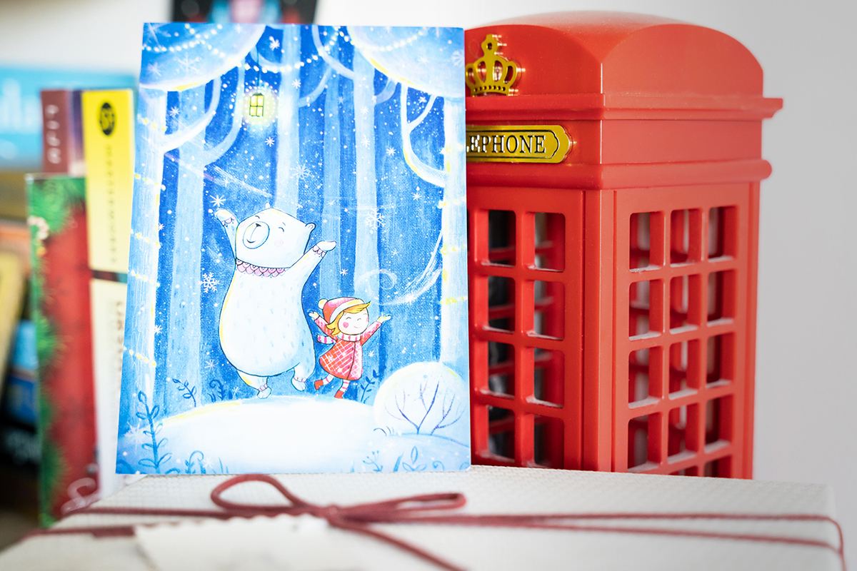 Holiday card on top of a gift box, holiday card design inspiration.
