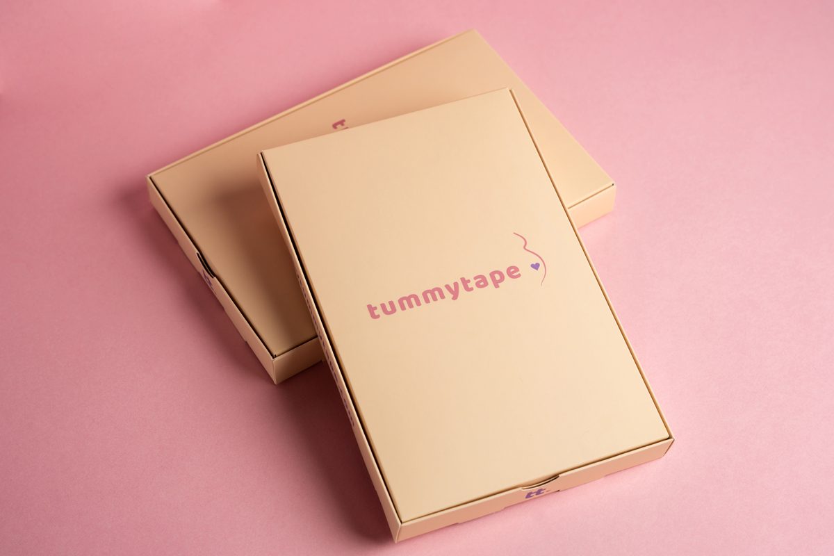Image illustrating how to choose the right paper for your printing project showing two boxes made of coated paperboard on a pink background.