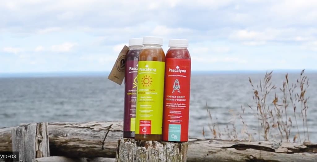 Image of three bottles with colorful labels for juice bottles.