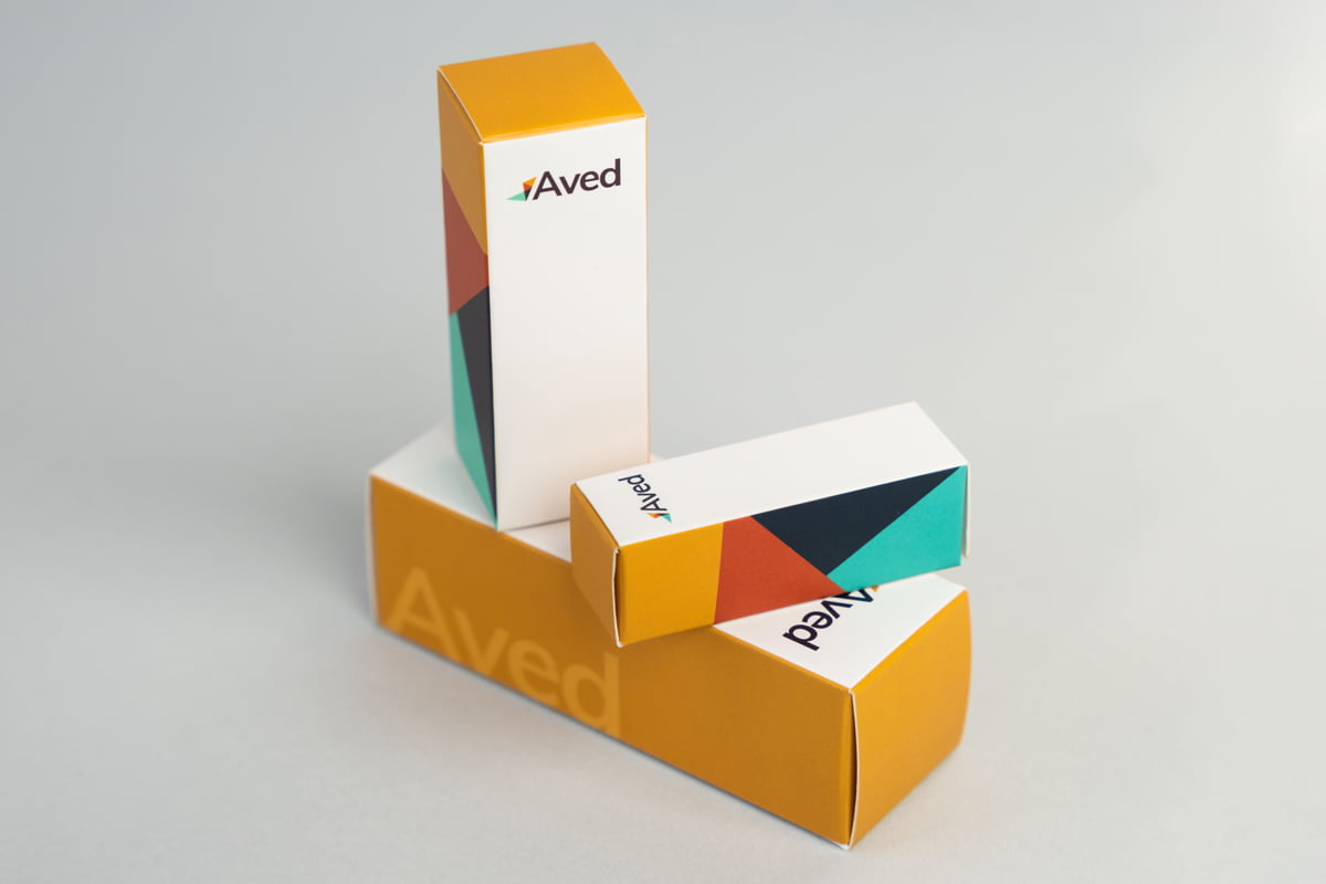 Image showing three colorful Reverse Tuck End boxes stacked on top of each other.