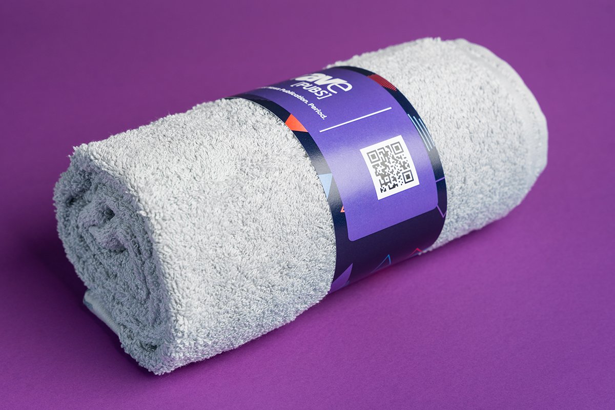 Types of packaging products - turquoise towel with a belly band around it.