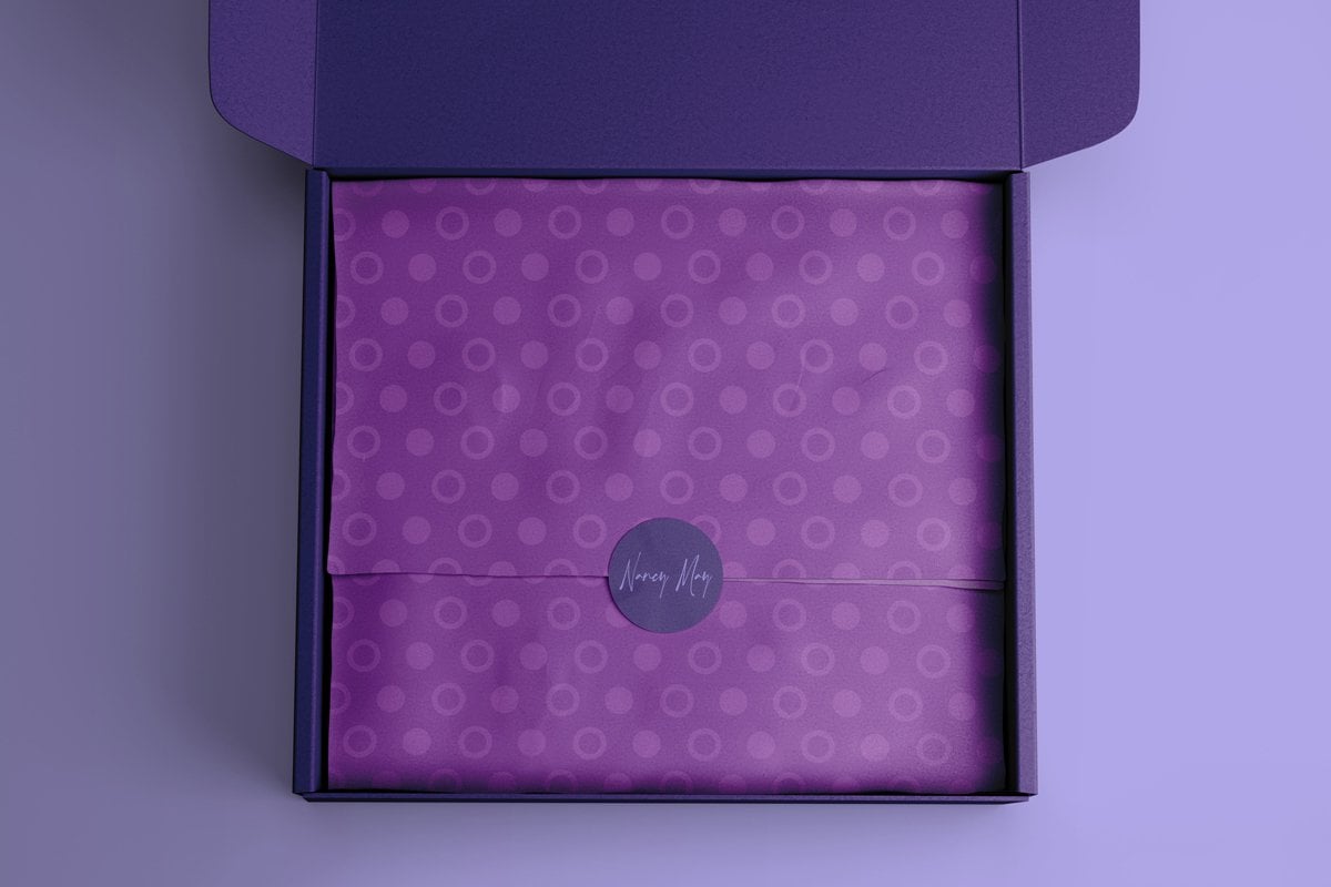 Types of packaging products - open box with purple wrapping paper and label in it.