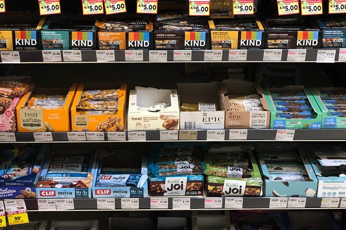 Types of packaging products - display boxes on the shelves with candy bars in them.