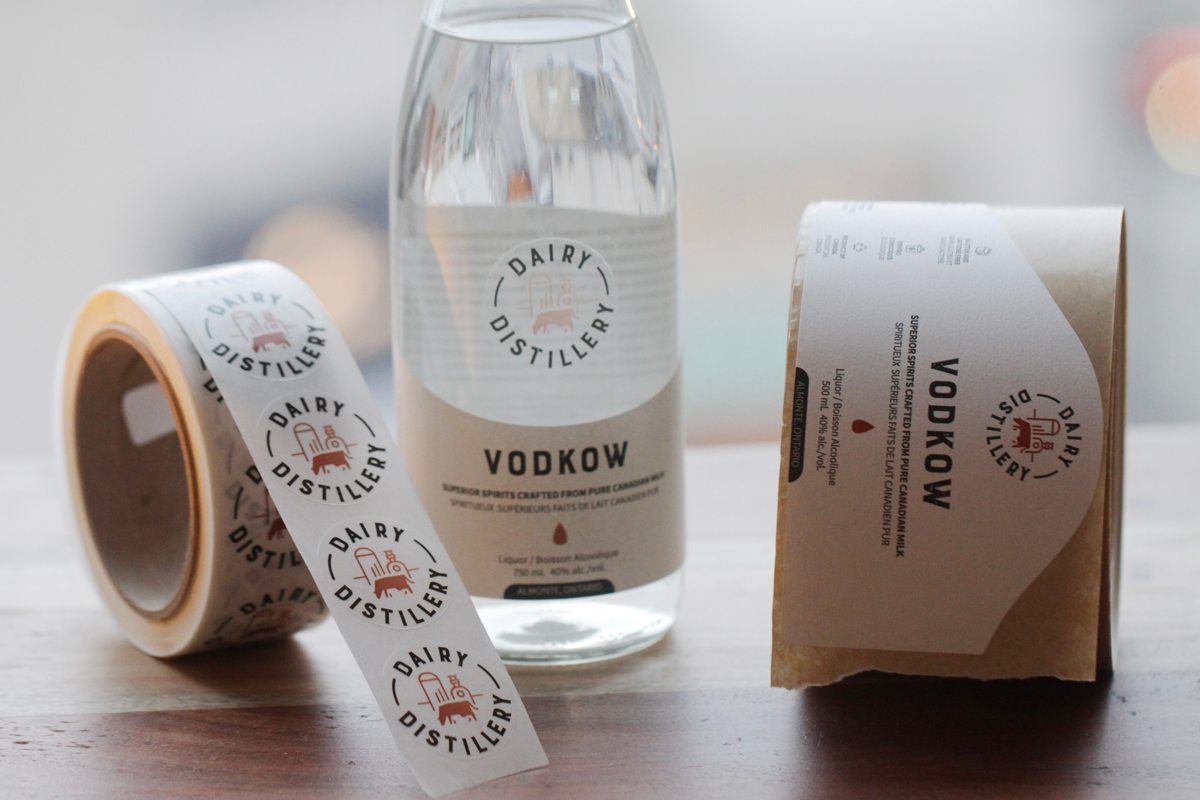 Types of packaging products - glass bottle with labels next to it.